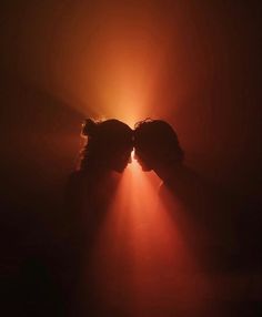 two people with their faces obscured by the light