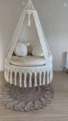 a white bed sitting on top of a wooden floor