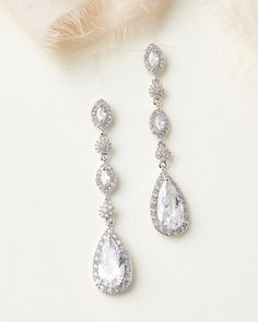 the bridal earrings are adorned with clear stones