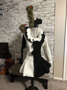 a mannequin is dressed in white and black