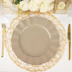 a table setting with gold and white flowers