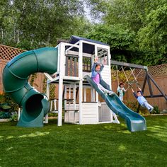 children playing on a play set in the backyard