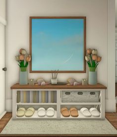 there is a painting on the wall and shoes are in front of it, along with other items