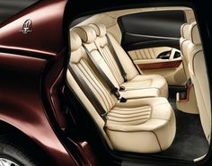 the interior of a luxury car is shown in this image, with its door open