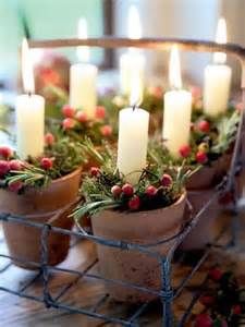 small potted plants with lit candles in them