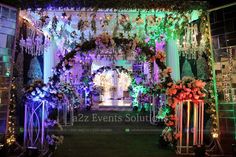 an outdoor wedding venue decorated with flowers and greenery