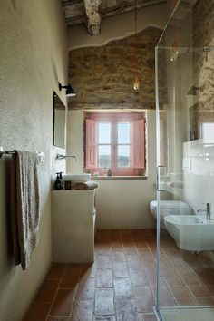 a bathroom with two sinks and a shower