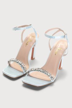 Go for glam in the Lulus Goldiena Sky Blue Satin Rhinestone Ankle Strap Heels! Sleek satin shapes these elegant heels that have a square footbed and a slender toe strap that's adorned with clear rhinestones in a variety of cuts. A matching strap wraps around and secures above the ankle with a silver buckle. Sculpted heel. 4" wrapped stiletto heel. Cushioned insole. Felted rubber sole has nonskid markings. Man made materials. Imported. Lulus | Goldiena Sky Blue Satin Rhinestone Ankle Strap Heels Sky Blue Wedding Shoes, Heels For Blue Dress, Powder Blue Heels, Pastel Blue Heels, Sky Blue Heels, Blue Wedding Heels, Quinceanera Heels, Blue Heels Wedding, Baby Blue Heels