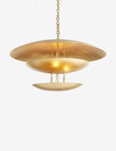 an oval light fixture hanging from a chain with two lights on each end and one light in the middle