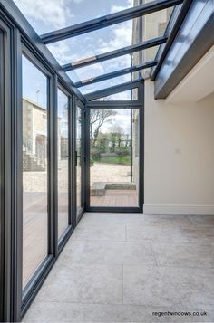 an empty room with glass walls and doors