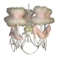 a chandelier that has several pairs of shoes hanging from it's sides