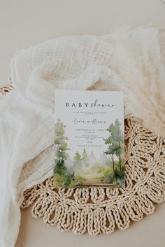 a baby shower book sitting on top of a doily next to a white blanket