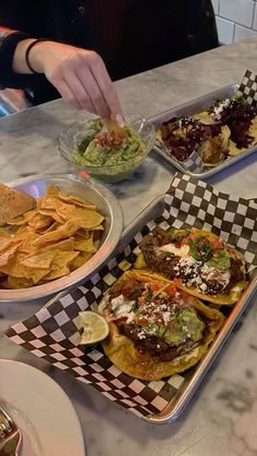 three trays filled with food sitting on top of a counter