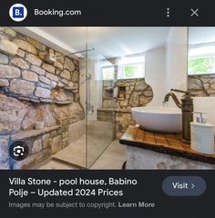 a bathroom with stone walls and flooring