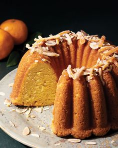 a bundt cake on a plate with almonds around it