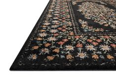 a black area rug with flowers on it