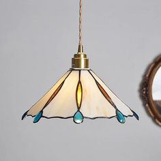 a lamp hanging from a ceiling next to a mirror