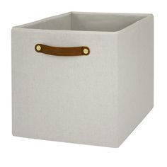 a white storage box with leather handles