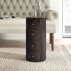 a white couch sitting next to a wooden table on top of a carpeted floor