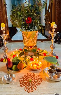 a table topped with candles and bowls filled with food