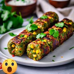 two vegetable rolls on a plate with a smiley face next to it and an emojble in the background