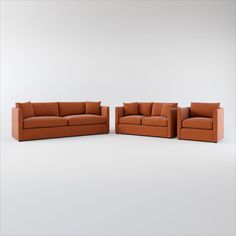 two couches and a chair sitting side by side in an empty room with white walls