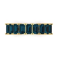 a blue and gold ring with three rows of emerald colored stones in the middle, on a white background