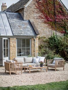 the outside of a house with furniture in front of it