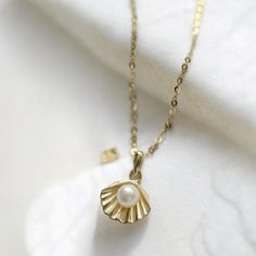 🌊✨Embrace the beauty of the sea with our stunning Shell Pendant Necklace. Crafted from 100% real 925 sterling silver and plated with 14k gold, this dainty necklace features a delicate freshwater pearl chain. Perfect for summer outings or adding a touch of elegance to any outfit, this necklace is a timeless addition to your jewelry collection. Key Features: * 14k Gold Plated: Adds a luxurious shine to the 925 sterling silver pendant. *  Freshwater Pearl Chain: Elegant and unique, perfect for a s Ocean-inspired Pearl Pendant Jewelry As Gift, Ocean-inspired Pearl Pendant Jewelry Gift, Ocean-inspired Gold Sterling Silver Jewelry, Ocean-inspired 14k Gold Jewelry, Summer Necklace, Shell Necklace, Necklace Dainty, Shell Pendant, Pearl Chain