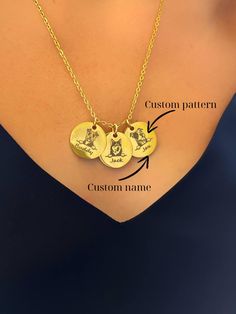 a woman wearing a necklace with three charms attached to it's neck and the words custom written on each disc