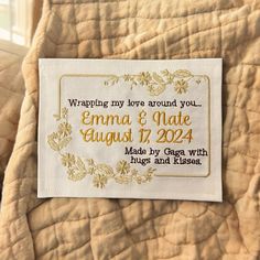 a label on the back of a quilt that says, wrapping my love around you emma & matte august 17, 2014 made by george with hugs and kisses