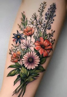 a tattoo with flowers and leaves on the arm, it is very nice to see