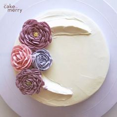 a cake decorated with flowers on top of a white plate