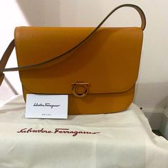 Gancini Rounded Flap Shoulder Bag. Comes With Dust Bag. Detachable, Adjustable Strap. Designer Tan Flap Bag For Travel, Designer Tan Shoulder Bag For Office, Elegant Flap Satchel, Designer Tan Satchel For Office, Designer Flap Shoulder Bag For Office, Designer Flap Bag With Leather Lining For Office, Designer Tan Bags For Work, Salvatore Ferragamo Handbags, Ferragamo Bag