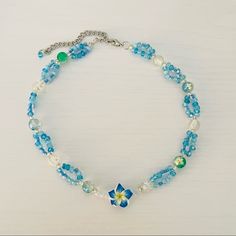 Blue Hawaii Tropical Beaded Necklace Handmade By Me And One Of A Kind! It Has Clear Beads And Loops Of Aqua Blue Tiny Beads. In The Middle Is A Beautiful Hibiscus Flower It’s A Short Necklace But The Length Can Be Adjusted To Wear It As A Choker As Well. Measures 14”-16” #Y2k #Coconutgirl #Surf #Tropical #Aesthetic Summer Blue Necklaces With Spacer Beads, Blue Beaded Necklaces For Jewelry Making In Summer, Blue Beaded Necklace With Spacer Beads For Summer, Blue Beaded Necklaces With Spacer Beads For Summer, Light Blue Beaded Flower Jewelry, Light Blue Flower-shaped Beaded Jewelry, Blue Beaded Flower Jewelry, Blue Flower-shaped Jewelry With Spacer Beads, Blue Flower-shaped Jewelry With Beaded Chain