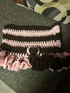 a crocheted skirt with a teddy bear on the front and pink ruffled bottom