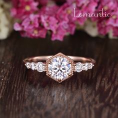 a close up of a ring on a table with flowers