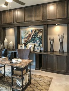 a living room filled with lots of furniture next to a wall mounted art work on the wall