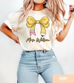 Custom Teacher Shirt, Comfort Colors Teacher Pencil Coquette Bow Shirt, Trendy Back to School Tee, Teacher Name Tee, Elementary Teacher Gift *How To Order* 1. Check photos for sizing and color options 📏 2. Select size and color from the drop-down menus ✨ 3. Add name in the personalization box ✨ 4. Add to cart & Place order 🛒 *PRODUCTION TIME* 1-5 days (Usually 2 days) *SHIPPING TIME* 2-5 days *PRODUCT DESCRIPTION* -Unisex T-Shirt -Comfort Colors Brand -100% cotton -Light/medium weight and extremely soft, this shirt is  sure to be your next favorite t-shirt. For T-shirt Sizes Please refer to the Listing Image. *CARE INSTRUCTION* Turn the shirt inside out and wash with cold water.  We recommend air drying, but can be placed in  dryer (lower heat is preferred). *PRINTING METHOD* DTG printin Fun Teacher Outfits Elementary, Fun Teacher Outfits, Elementary Teacher Gifts, Teacher Outfits Elementary, Teacher Fits, Dream Classroom, Future Job, Bow Shirt, Teachers Day Gifts