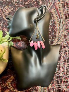 dangle earrings with pink quartz and metal gold moons Pink Dangling Charms Drop Earrings, Pink Drop Earrings With Dangling Charms, Pink Dangle Chandelier Earrings For Pierced Ears, Pink Brass Dangle Earrings, Pink Brass Dangle Jewelry, Pink Metal Drop Earrings, Pink Metal Chandelier Earrings, Pink Crystal Dangle Earrings With Ear Wire, Pink Bohemian Crystal Earrings For Pierced Ears