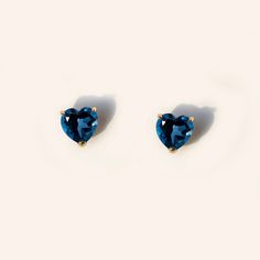 Forever classic, heart-shaped natural London blue topaz stud earrings handcrafted in 9K solid gold. Made to Order. Ship within 3-4 weeks. - Stone info: 5mm heart cut natural London blue topaz - Stone weight: 1.2ctw - Sold as A Pair. - The earrings come with 10K gold silicone backings. - Made in 9 karat gold. - Stamp with 9K. Cheap Handmade Blue Heart Earrings, Lexy Cross, Stone Earrings Studs, Pokemon Jewelry, Blue Stud Earrings, Gold Topaz, Silver Jewelry Design, Blue Topaz Stone, Dainty Studs