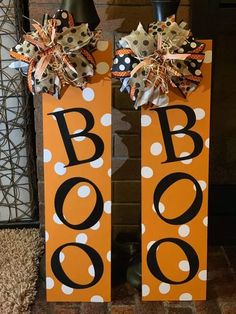 two halloween door hangers decorated with polka dots and black letters that say boo on them