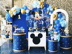 a mickey mouse birthday party complete with balloons and decorations, including blue and gold decor