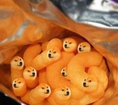 a bag full of little teddy bears in it's wrapper with eyes drawn on them