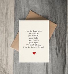 a card with the words i am in love with your mother on it and a red heart