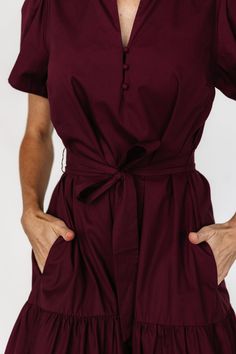 A simple and easy-to-wear dress with cute details Deep wine color that pulls purple Cotton material has no stretch Fit runs big, we recommend sizing down if wanting a more fitted look V-neckline with ruffled collar Three functional loop buttons on front bodice Removable self-tie waist sash Functional side pockets Tiered skirt Unlined 100% Cotton Trina is 5'6, cup size 32D, size 2 and is wearing size XS Dress Big Size, Big Size Dress, Baltic Born, Waist Sash, Ruffled Collar, Poplin Dress, Wine Color, Wine Colored, Tier Skirt