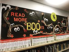 a bulletin board that has been decorated with googly eyes and leaves on it in a library