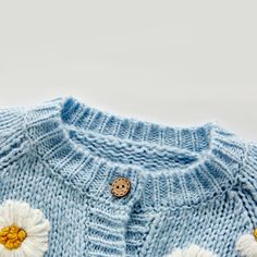 Let your unique style shine with the Daisy Dreams Knitted Cardigan. Its lightweight construction provides superior comfort and flexibility, while its intricate knitwork creates a luxurious look. Style and comfort come together in perfect harmony. Get yours today! Our knitted cardigan is perfect for your little fashionista in all seasons, providing both comfort and style. Made from a blend of cozy woolen yarn, this cardigan is gentle on your baby's delicate skin. The cardigan features a delightfu Spring Cable Knit Acrylic Cardigan, Spring Acrylic Cable Knit Cardigan, Soft Knit Acrylic Sweater Coat For Spring, Spring Soft Knit Acrylic Sweater Coat, Spring Knitted Acrylic Sweater, Fitted Knitted Sweater Coat, Spring Cozy Sweater In Acrylic Yarn, Cozy Acrylic Yarn Sweater For Spring, Blue Soft Knit Cardigan