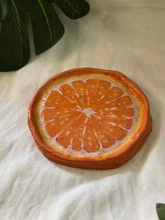 Introducing the Orange Trinket Tray, expertly crafted from the finest air dry terra cotta. Each tray is hand sculpted and hand drawn with acrylic markers, giving it a unique organic shape. Use it as the perfect jewelry organizer, clear coated for maximum durability. Elevate your organization game now! Size 9cm diameter Orange Trinket Dish, Fruit Trinket Dish, Air Clay Tray, Homemade Trinket Dish, Air Dry Clay Ring Dish, Air Dry Clay Jewelry Dish, Clay Ring Tray, Trinket Tray Clay, Air Dry Clay Trinket Dishes