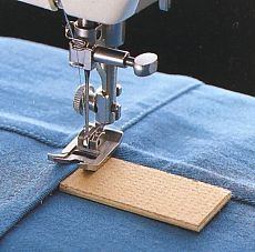 a sewing machine is on top of a blue piece of cloth